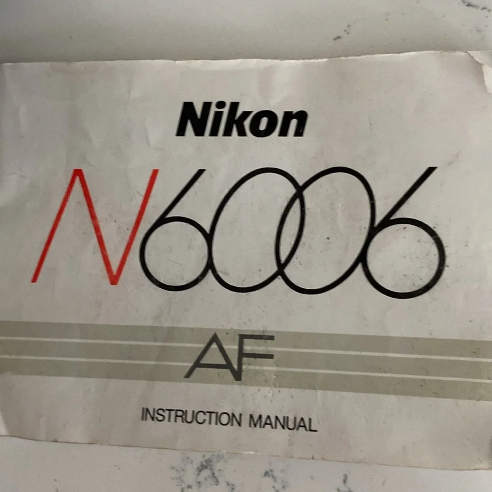 Nikon N6006 AF camera with lenses and leather bag.